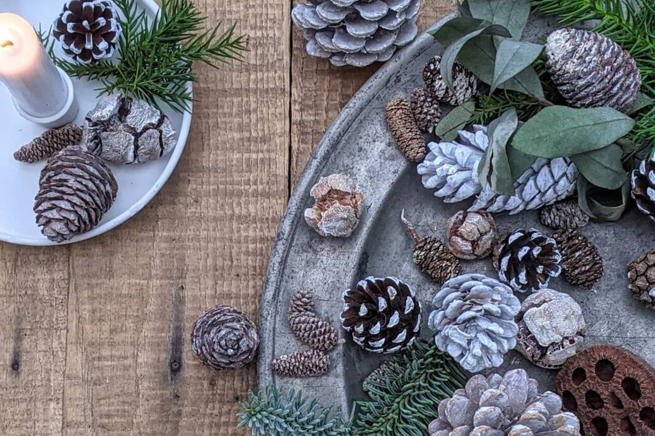 Natural Christmas decorations and assortment of pine cones&nbsp;on a tray