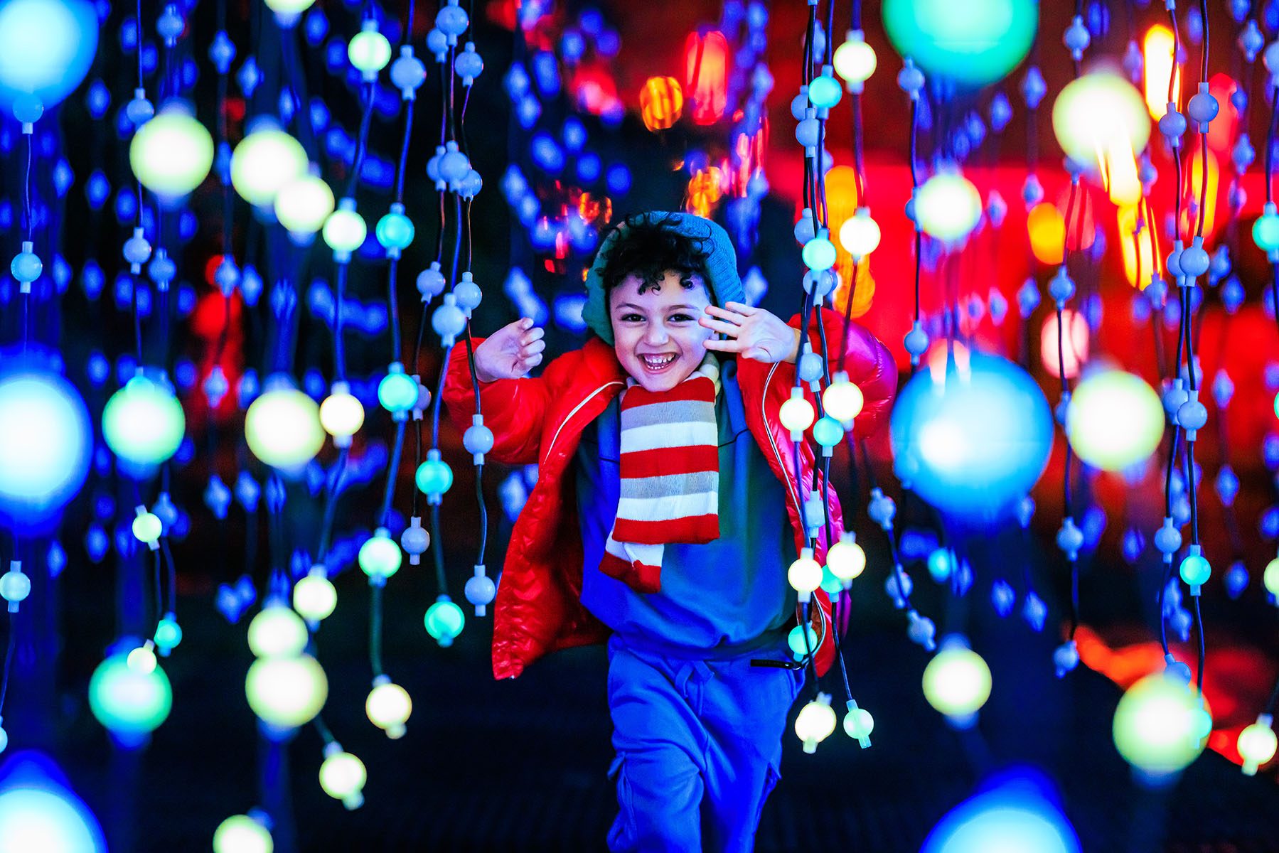 Boy in light installation at Christmas at Kew