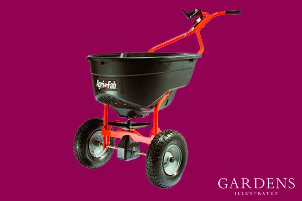 Agri-Fab Push Broadcast Smart Spreader on a pink background