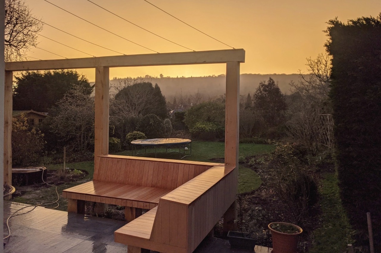 A newly installed oak pergola and archway has an in-built sofa and steel wires to support climbing plants