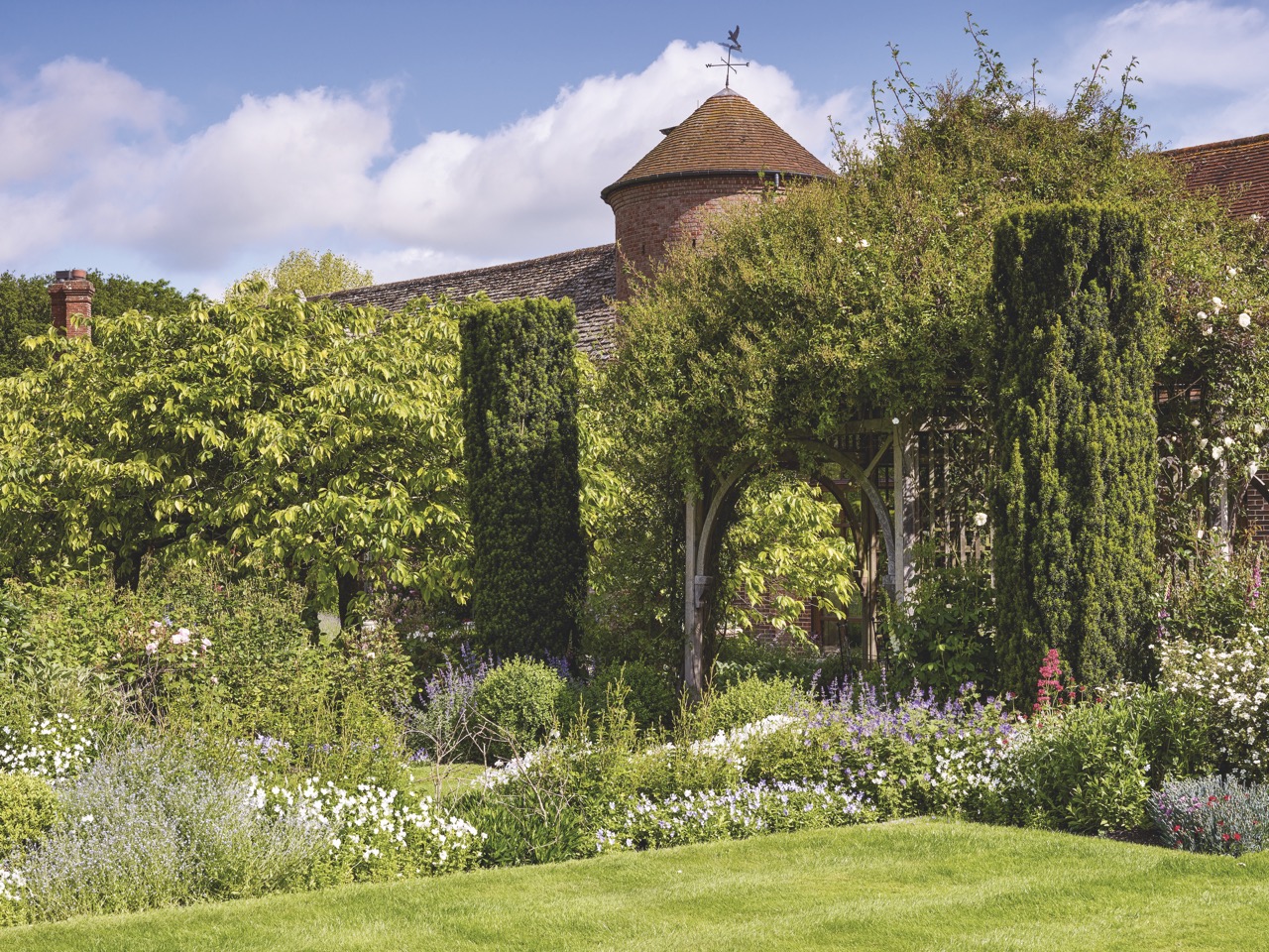 The striking rose-covered pergola in a Berkshire garden designed by Arabella Lennox-Boyd