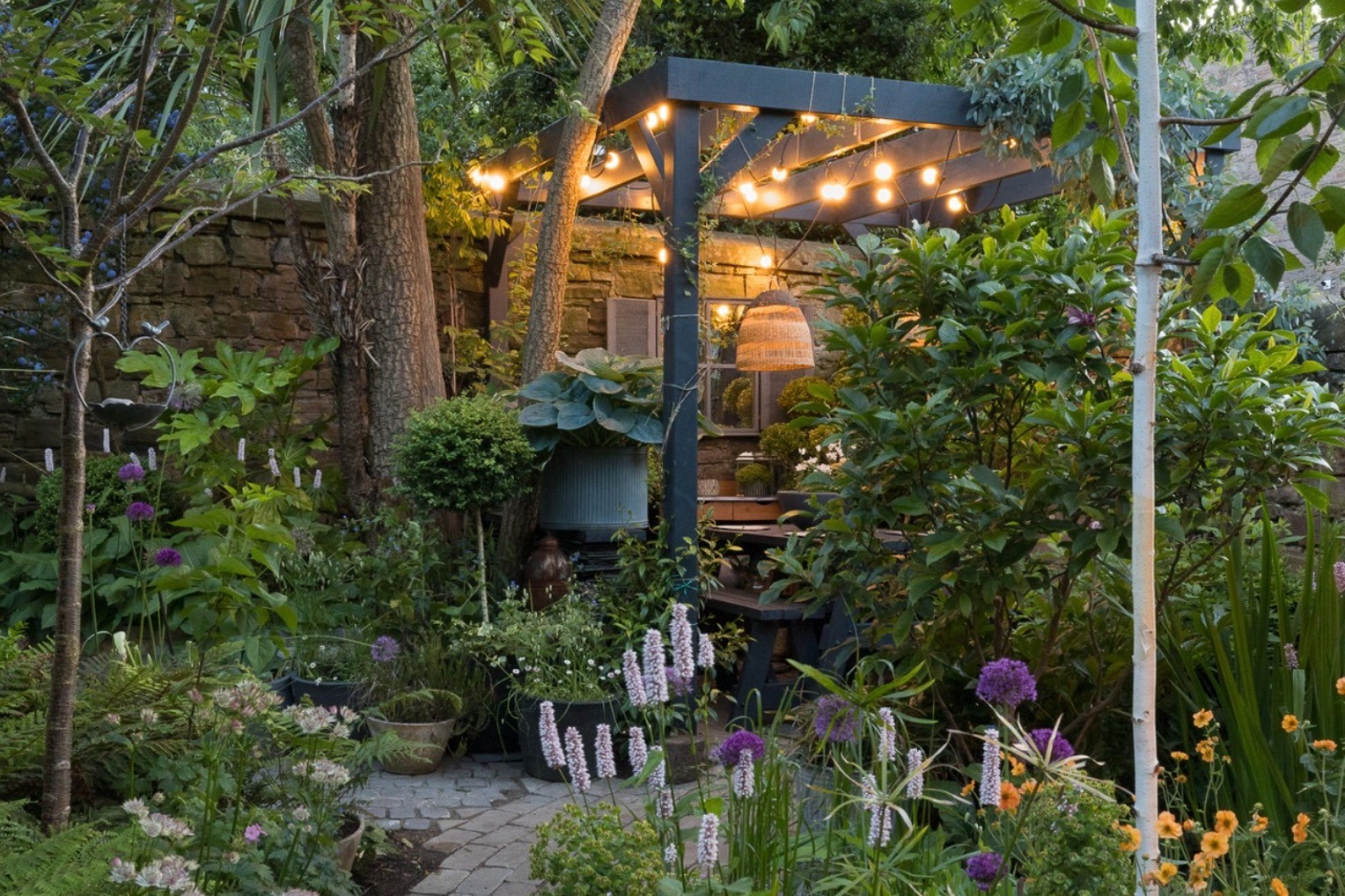Libby Webb created her own pergola-covered dining area at the bottom of her garden