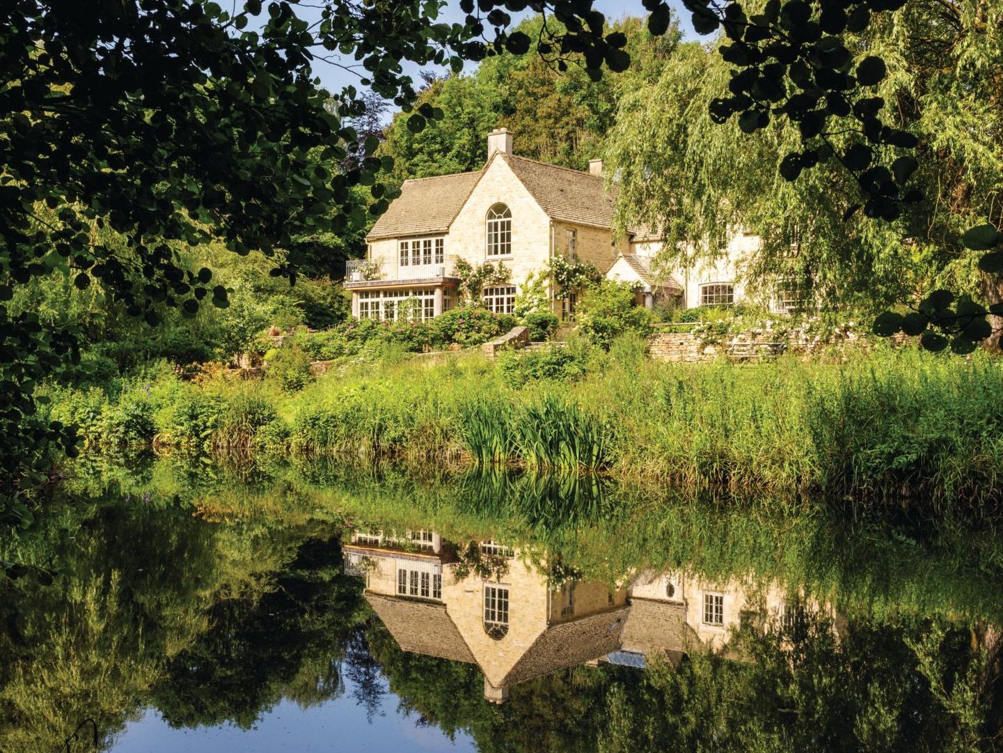 House in background with river and reeds