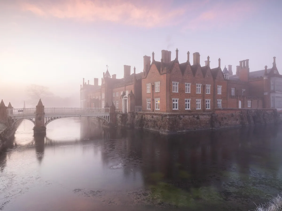 Helmington Hall in Suffolk Stately home in mist surounded by moat