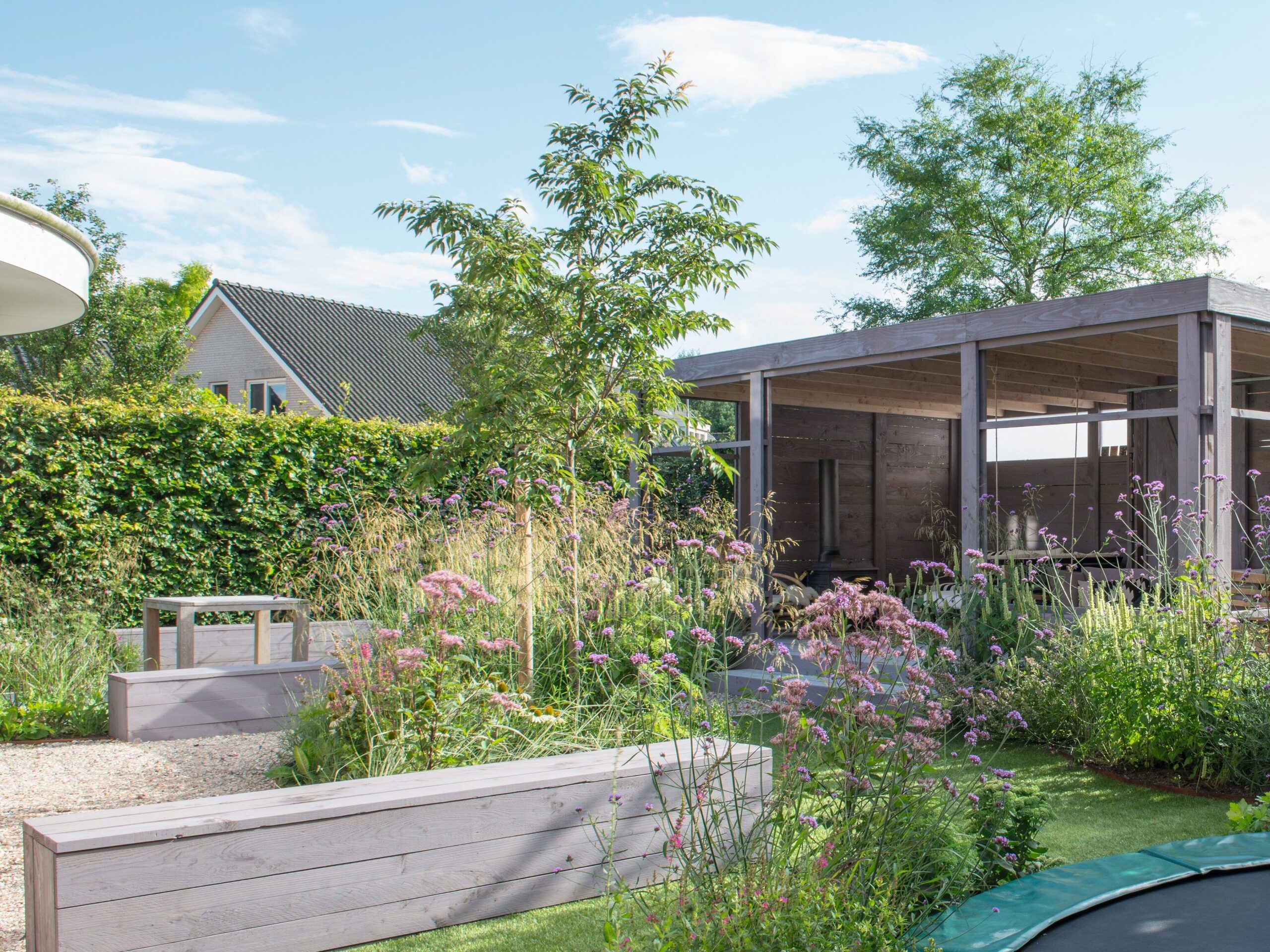 A submerged trampoline in a family garden in the Netherlands designed by Carrie Preston
