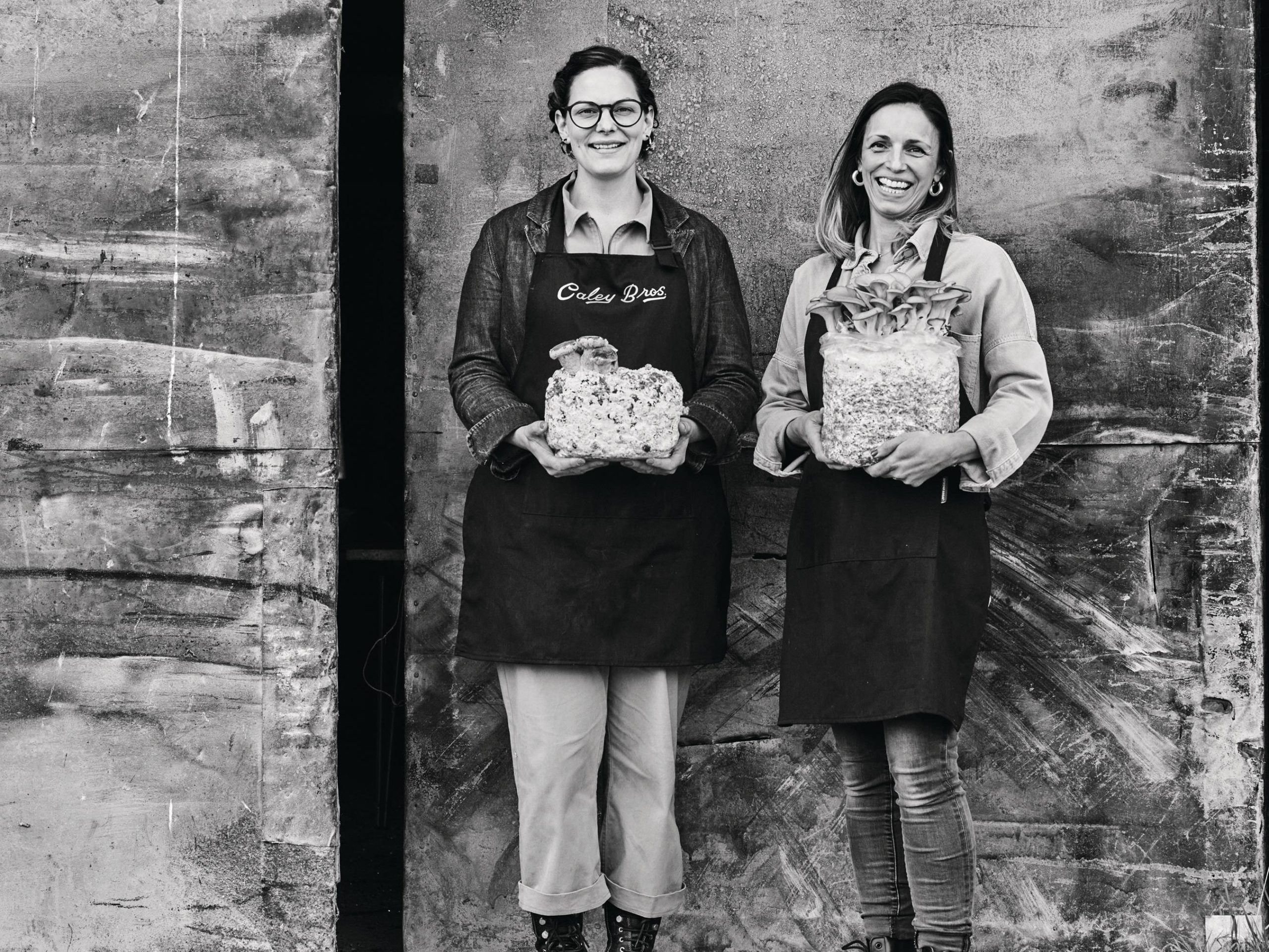 Two women holding mushrooms