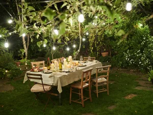 Still life of a dressed dining table set for six people Dining table outside in a garden. Al fresco dining.