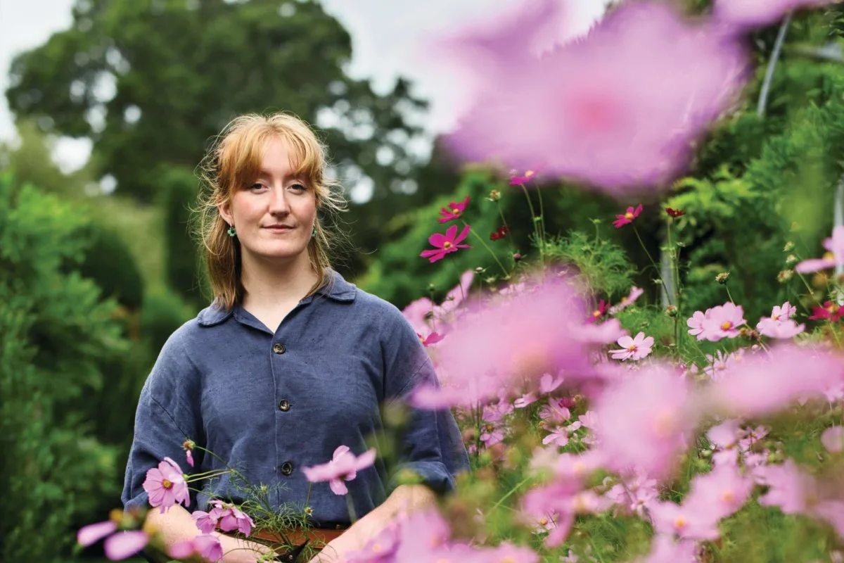Roisin Taylor Woman stood in flower garden