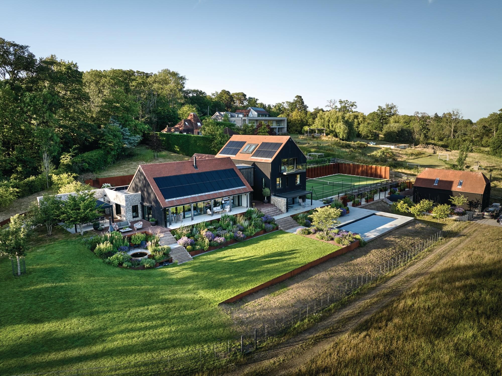 A photograph of a house from up high with a large lawn