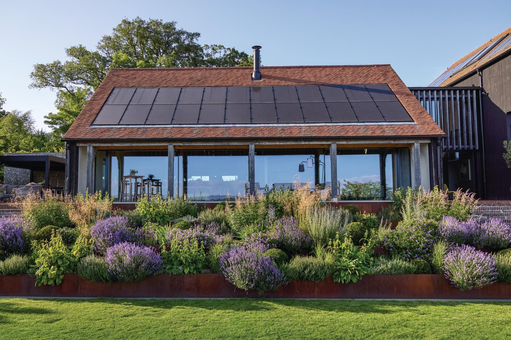 A house with solar panels and borders in front