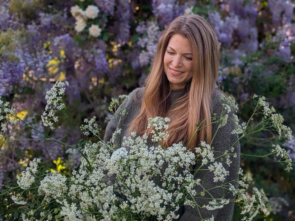 Annie Reilly standing with flowers in the garden