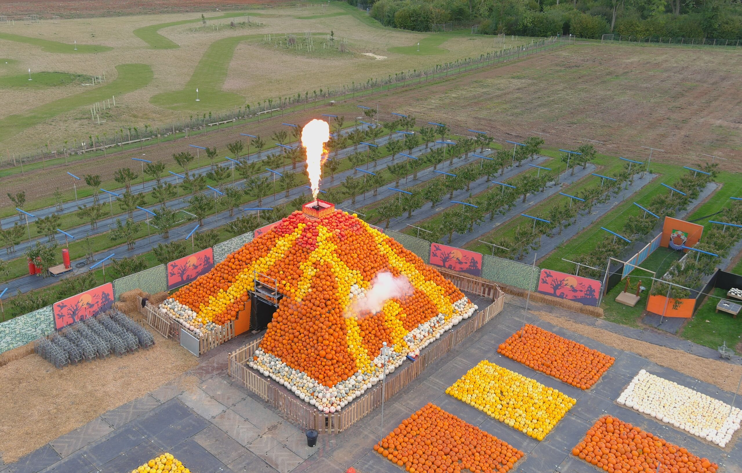 Volcano made of pumpkins with fire coming from the top