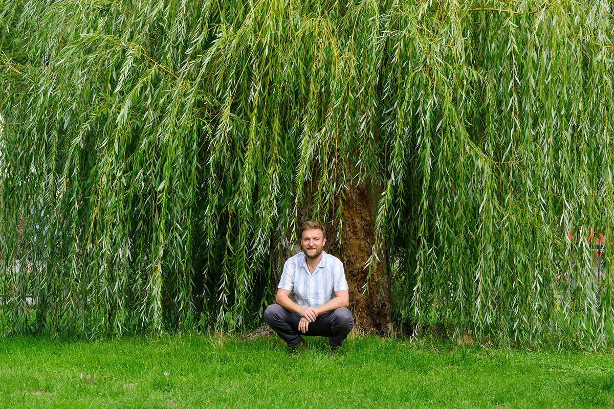 RHS Stonehouse in Bloom (21st September 2026) Man crouching in front of a tree