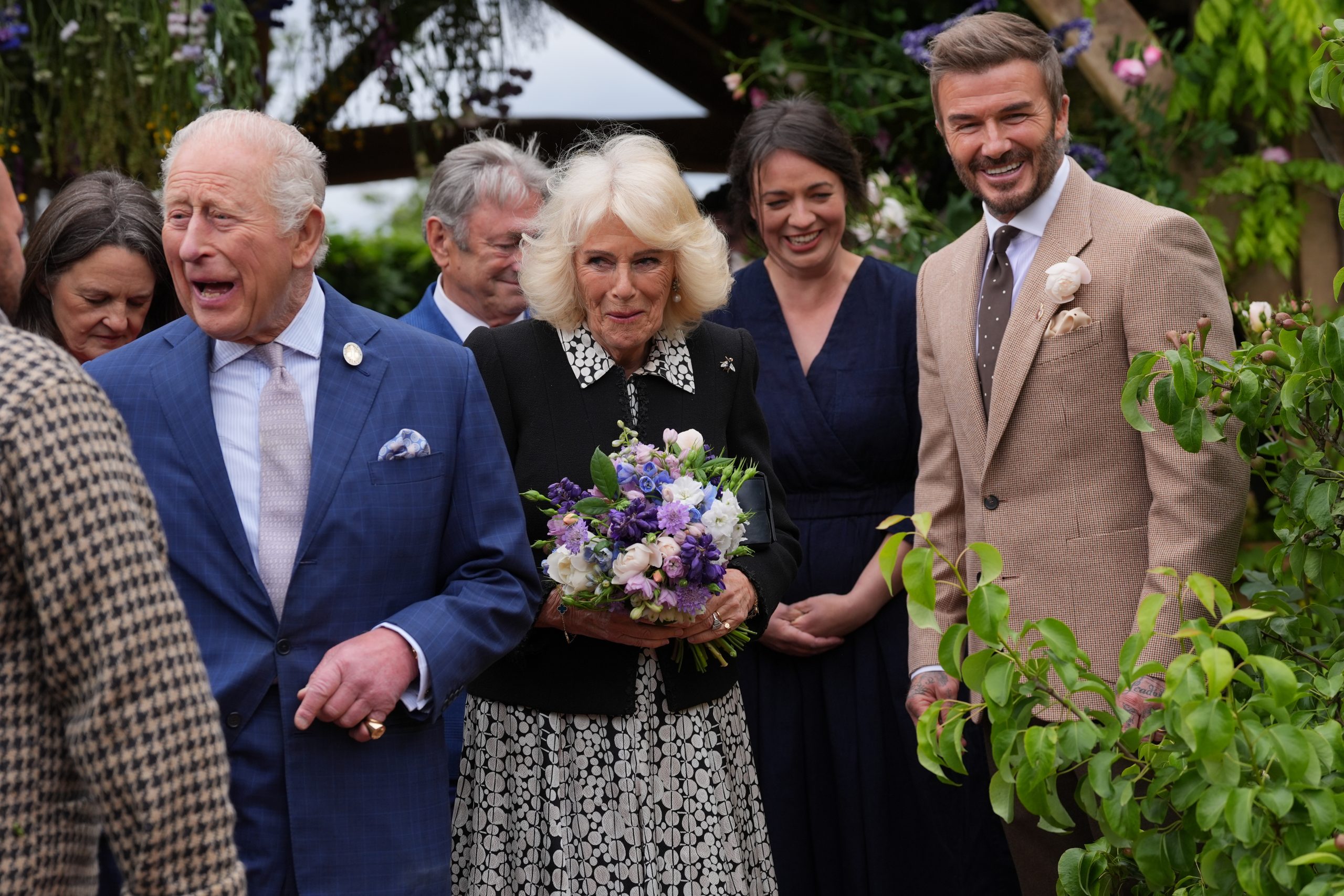 Sir David Beckham greets Queen Camilla as she arrives with King Charles III for their visit during the press day ahead of the 2026 RHS Chelsea Flower Show © Yui Mok - WPA Pool/Getty Images
