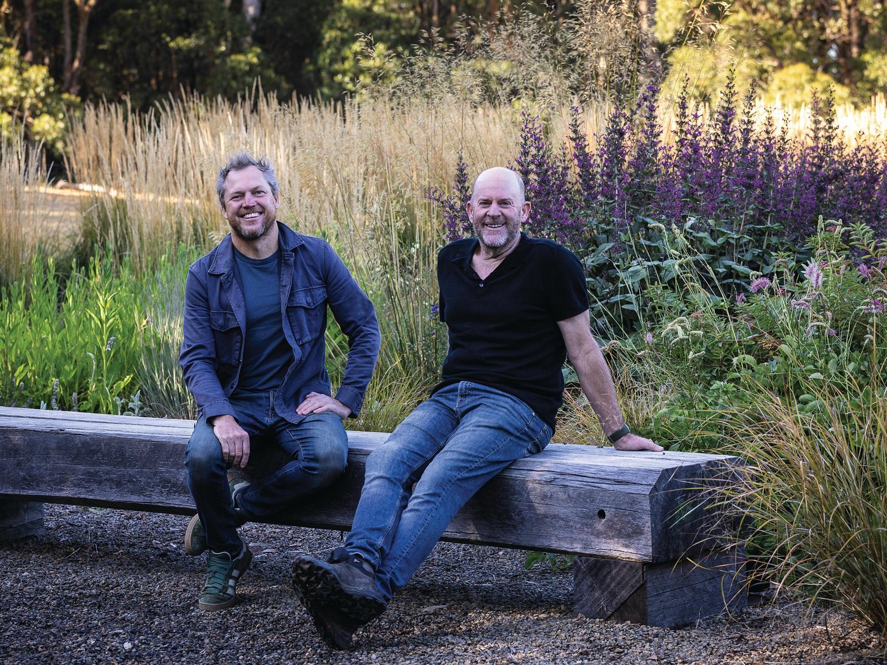 Two men sat on bench in garden