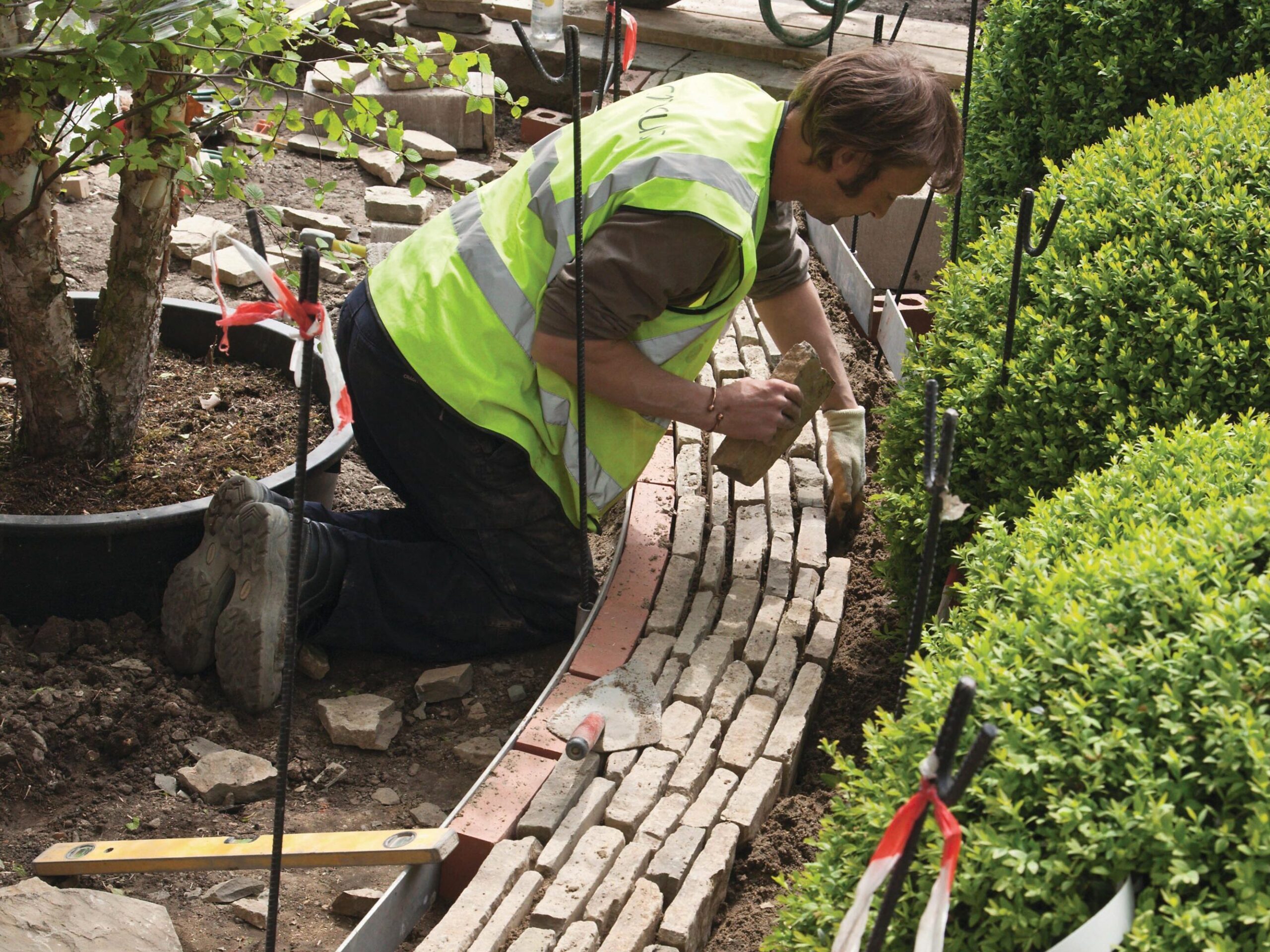 Man laying paving in garden