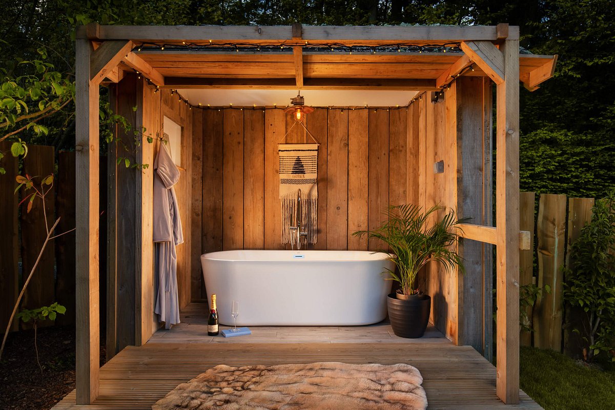 A bath tub in an outdoor covered area at Hinton Hideaways, Somerset