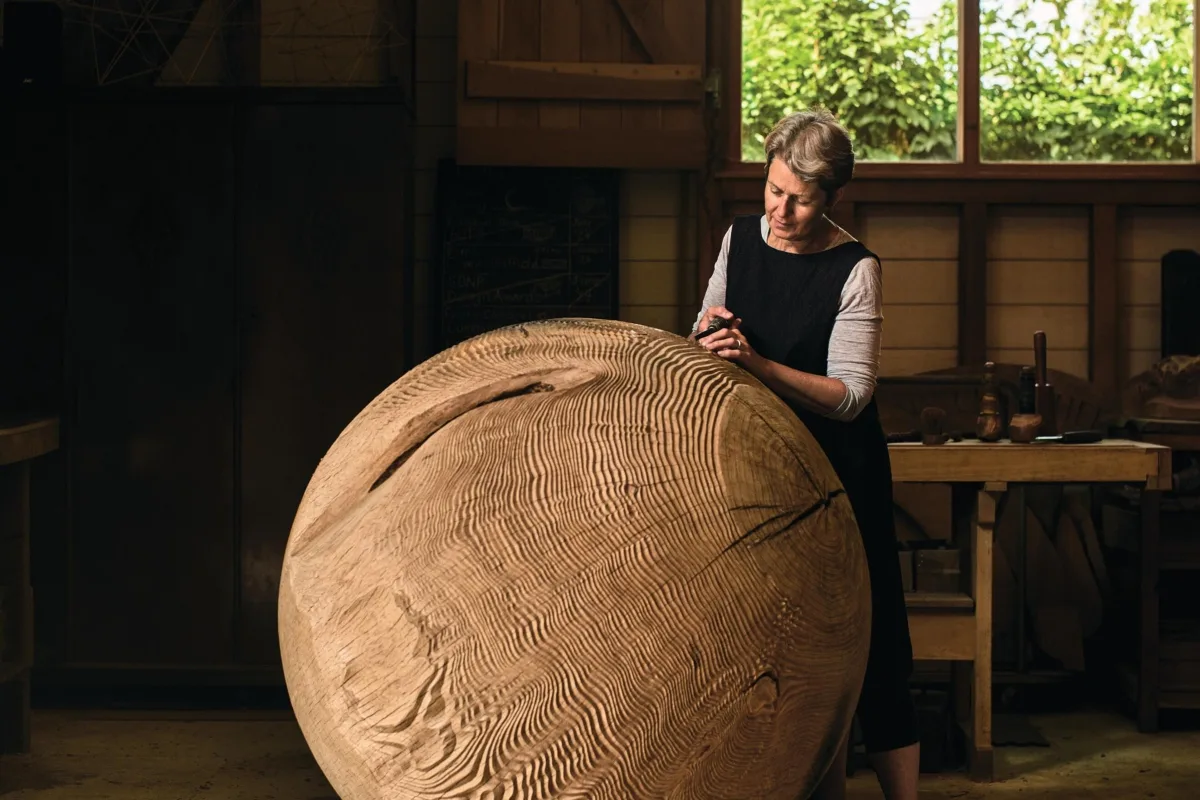 Alison Crowther sculpture Woman carving a wooden sculpture