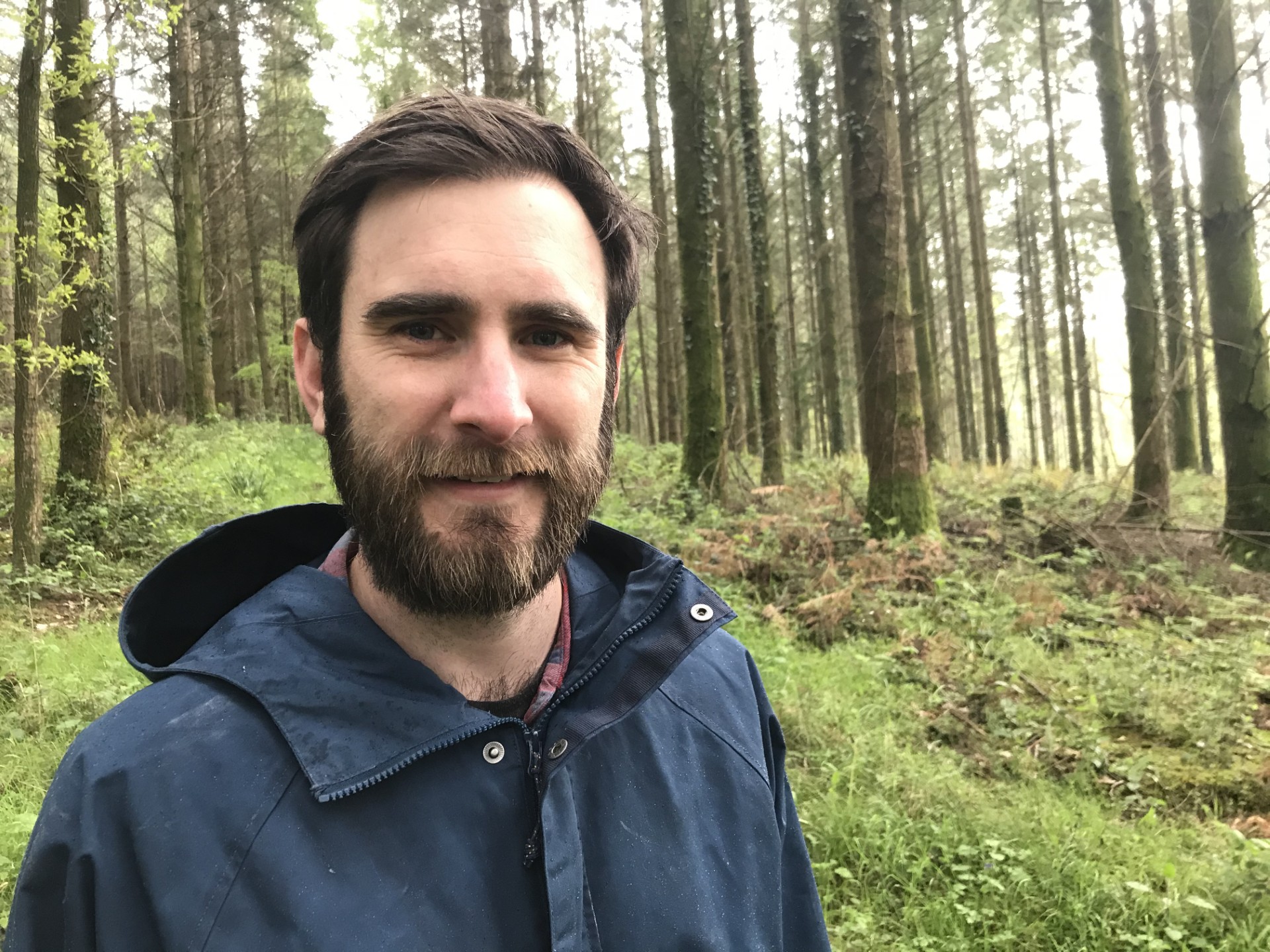 David Smith, Advocacy and Social Change Manager at the invertebrate conservation charity Buglife, standing in a forest
