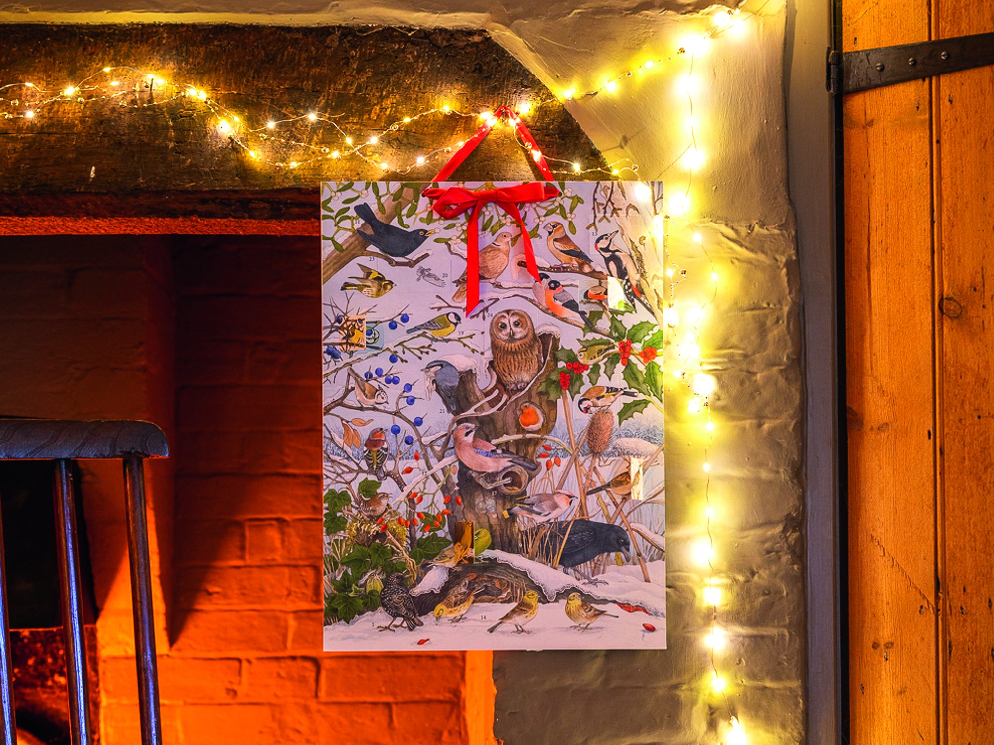 Sarah Raven Birdsong Advent Calendar hung on a fireplace