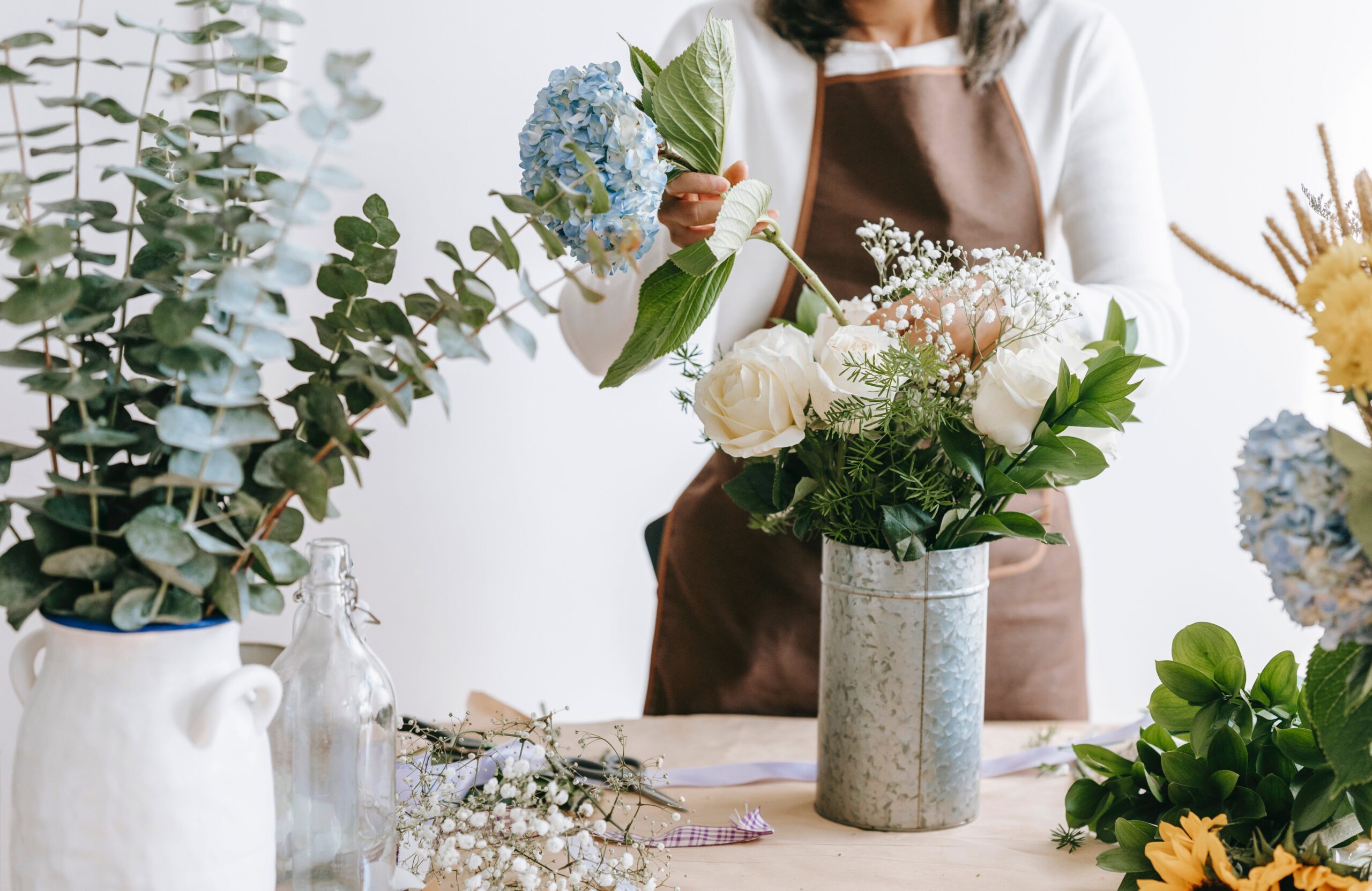 Woman making floral arrangement