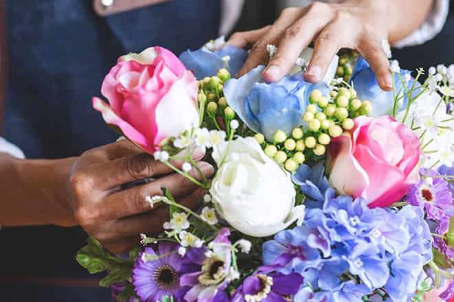 Person making floral bouquets