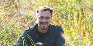 Jamie Butterworth hero Man in grass with dog