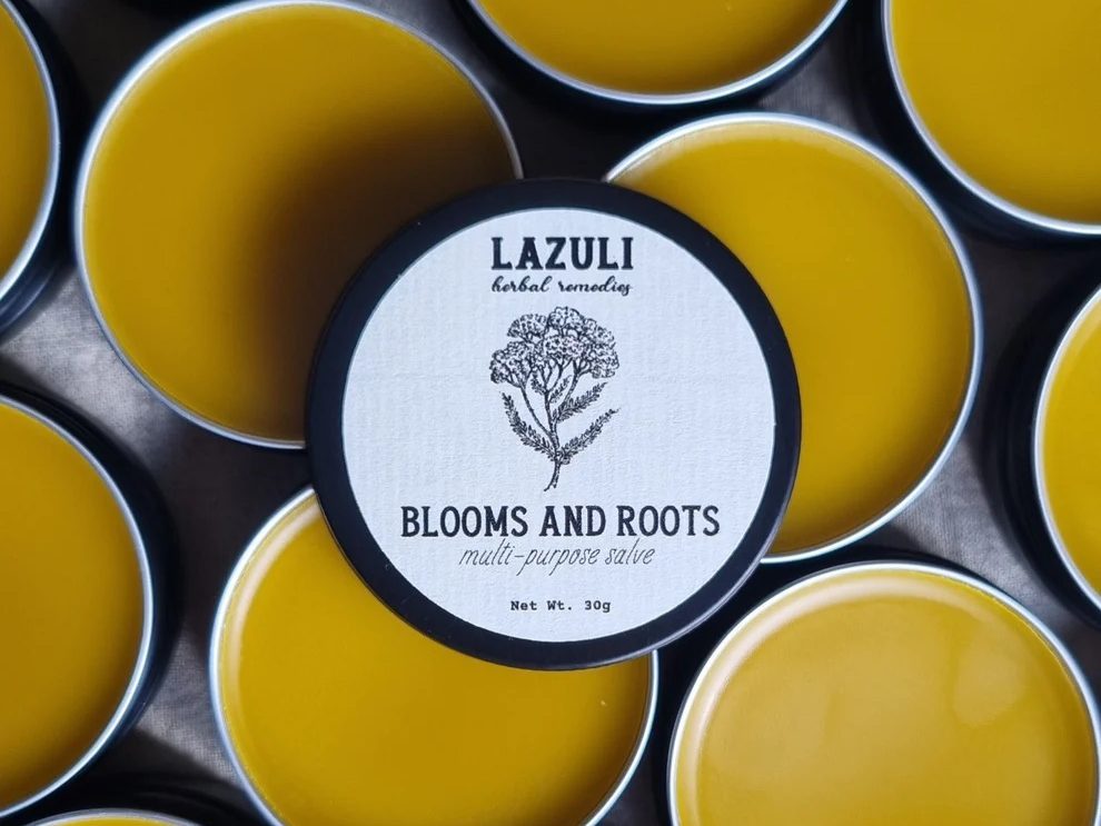 Tins of yellow Lazuli herbal balm