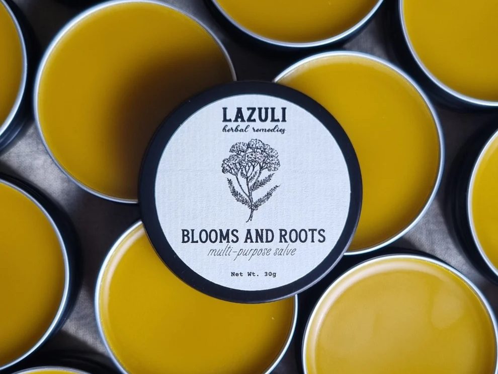 Tins of yellow Lazuli herbal balm
