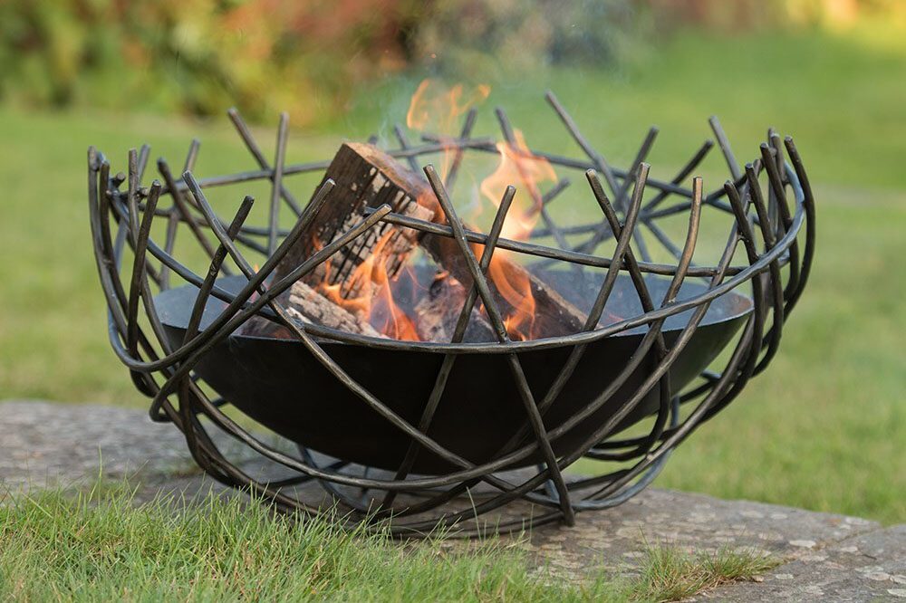 Nest iron fire pit bowl in a garden