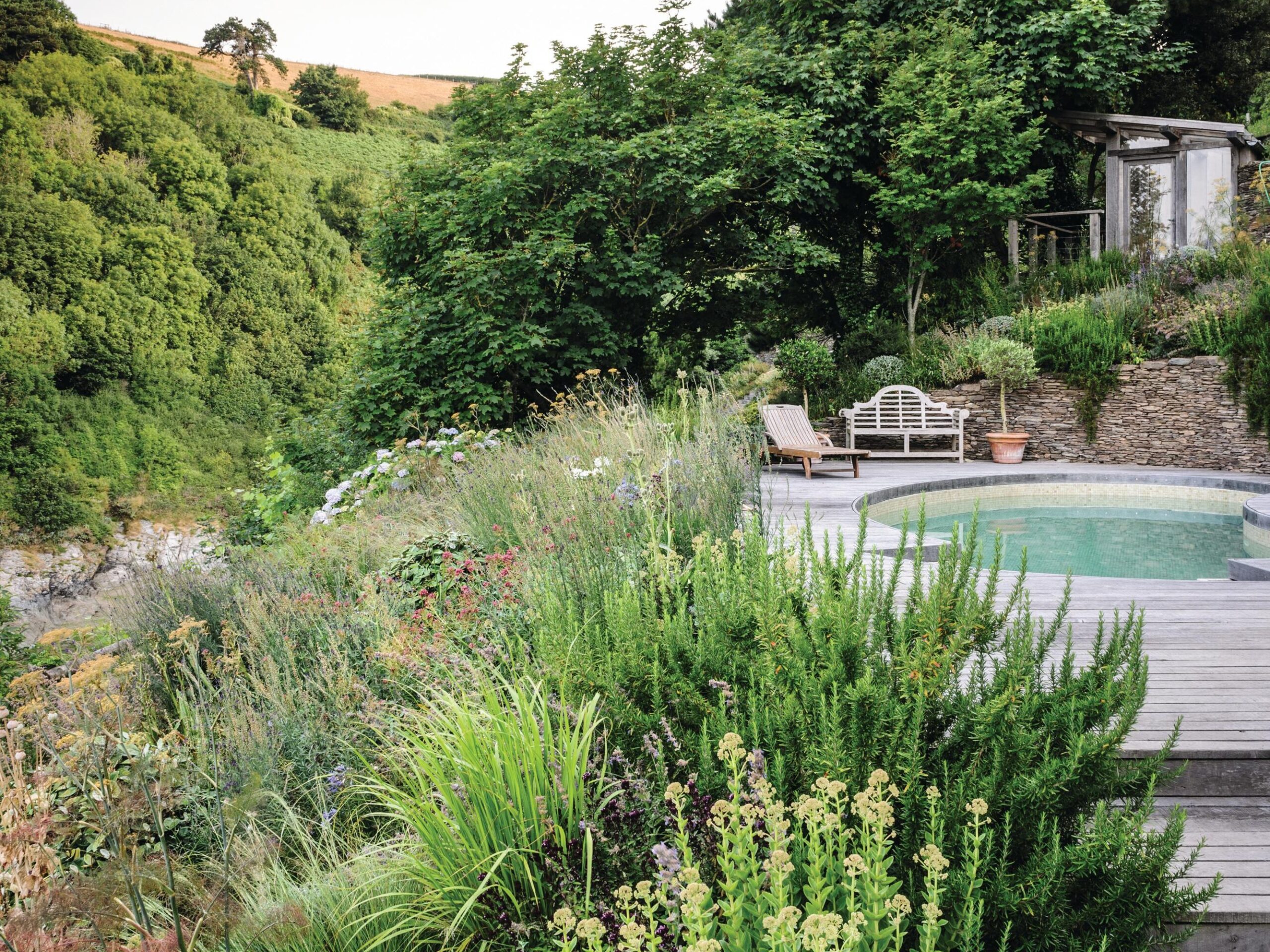 Near to the sea, trial and error has shaped the planting. Here, where the salt and wind are at their most fierce, sedums, rosemary, eryngiums and oregano tough it out through summer gales. Most plants are dormant during the winter, allowing them to avoid the worst of the weather.