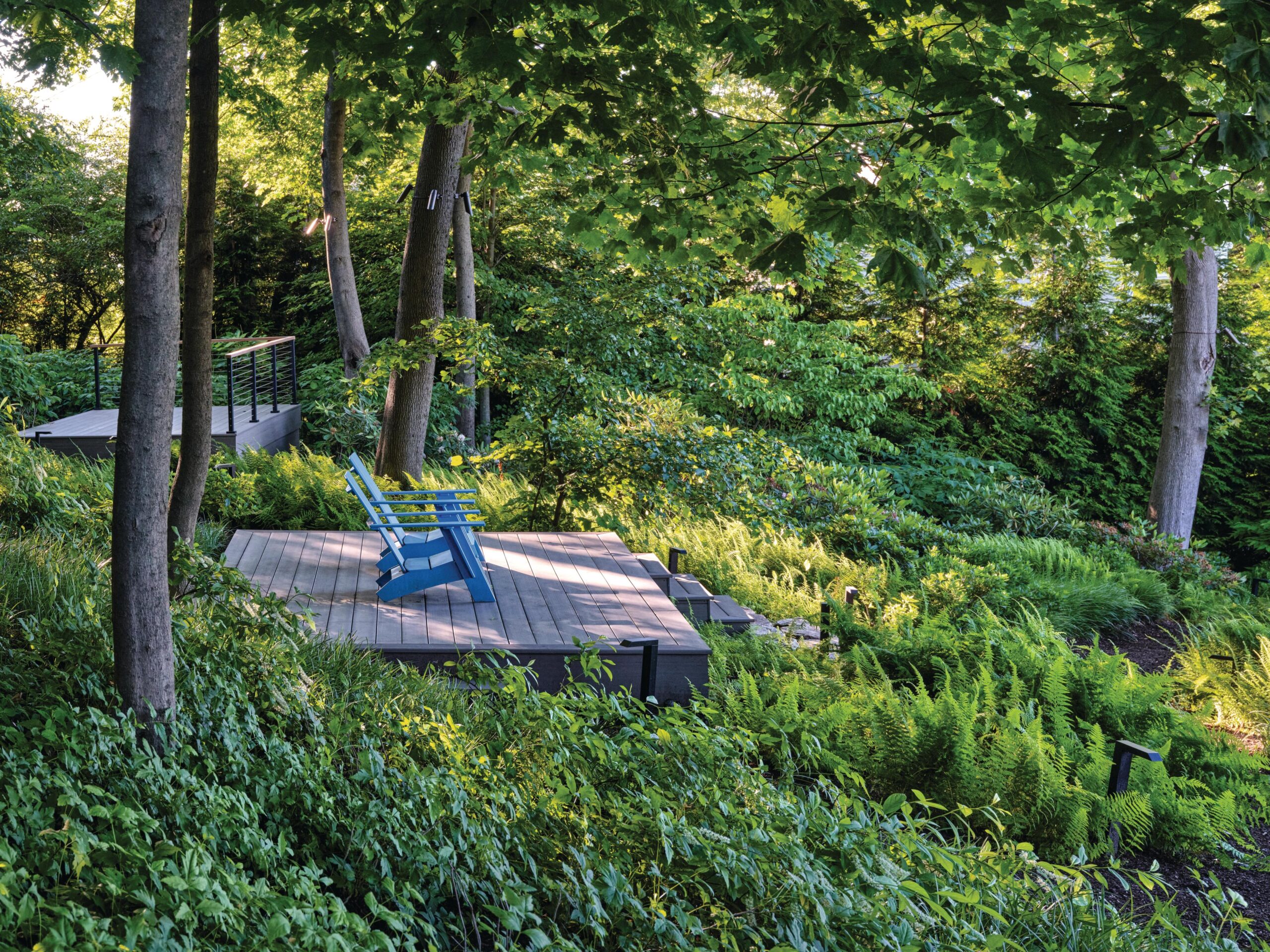 Garden chairs on decking in trees