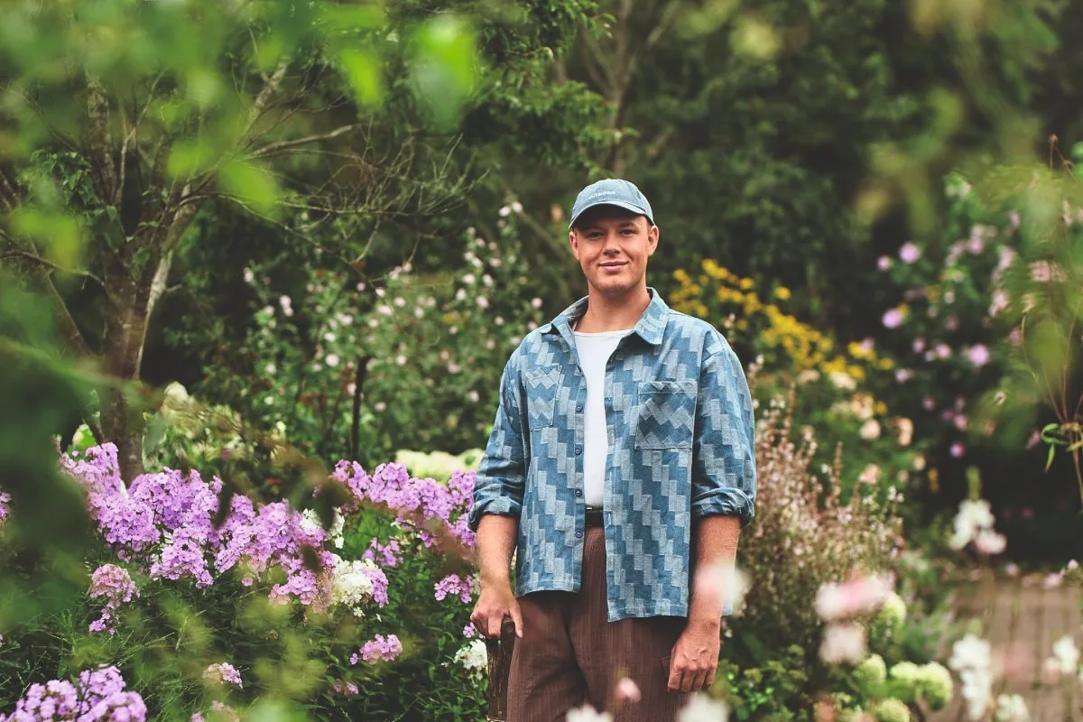 Drag Queen Gardener, aka Tom Leonard Man stood in garden