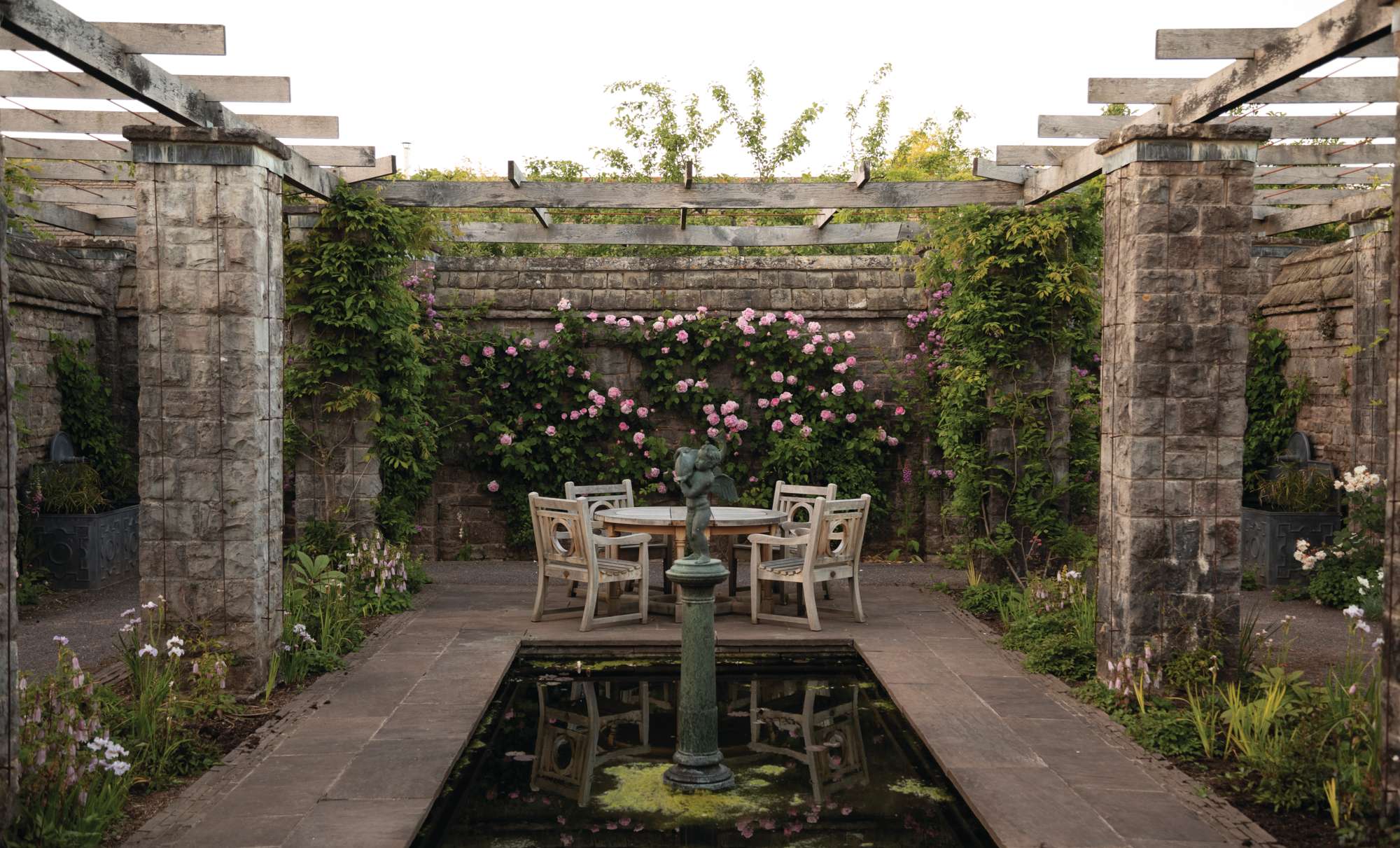 A central pond and seating area in the Pergola Garden at Mounton House