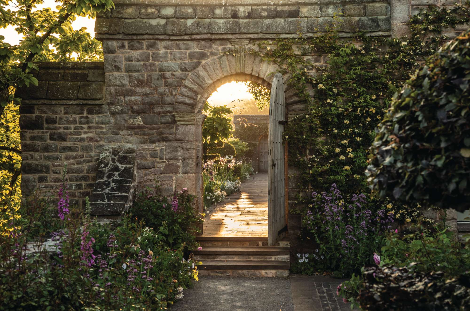 A door in a stone wall at The Pergola Garden at Mounton House