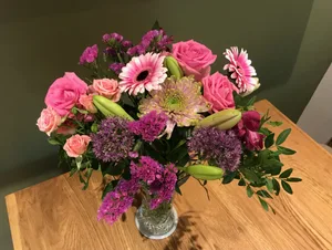Bunches flower delivery in vase Bunches flower delivery in vase on a wooden table