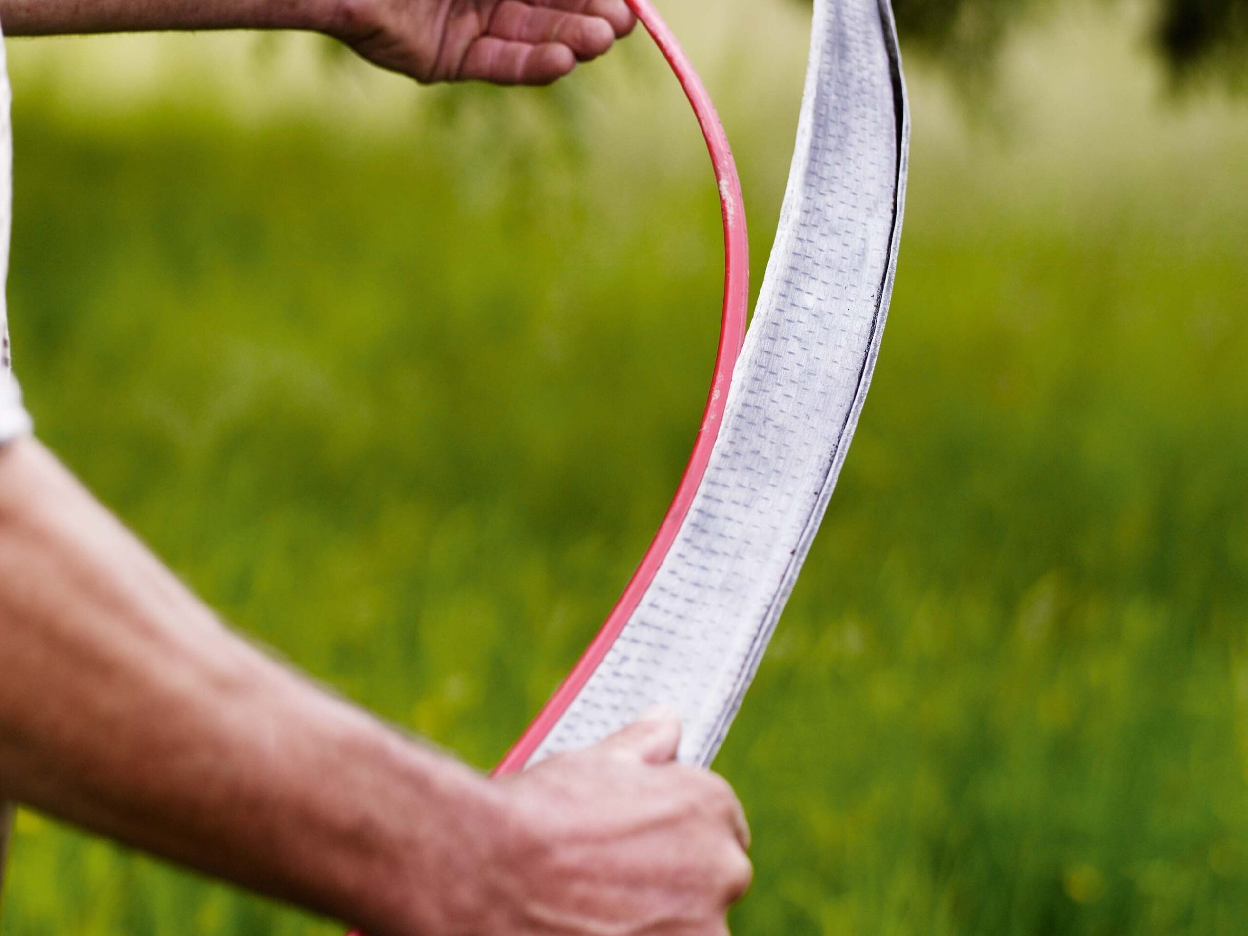 Simon Damant scything in a field at the Wimpole Estate