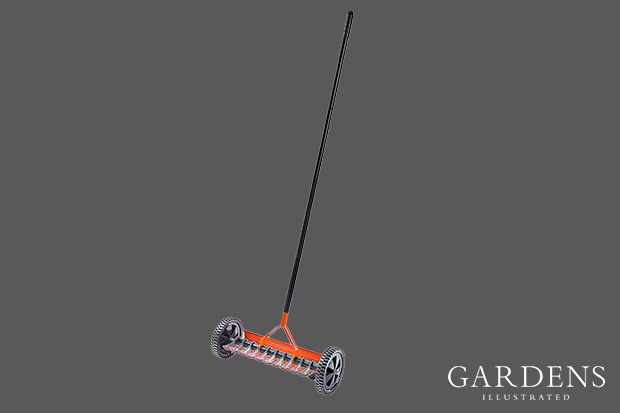Rolling Lawn Scarifier on a grey background