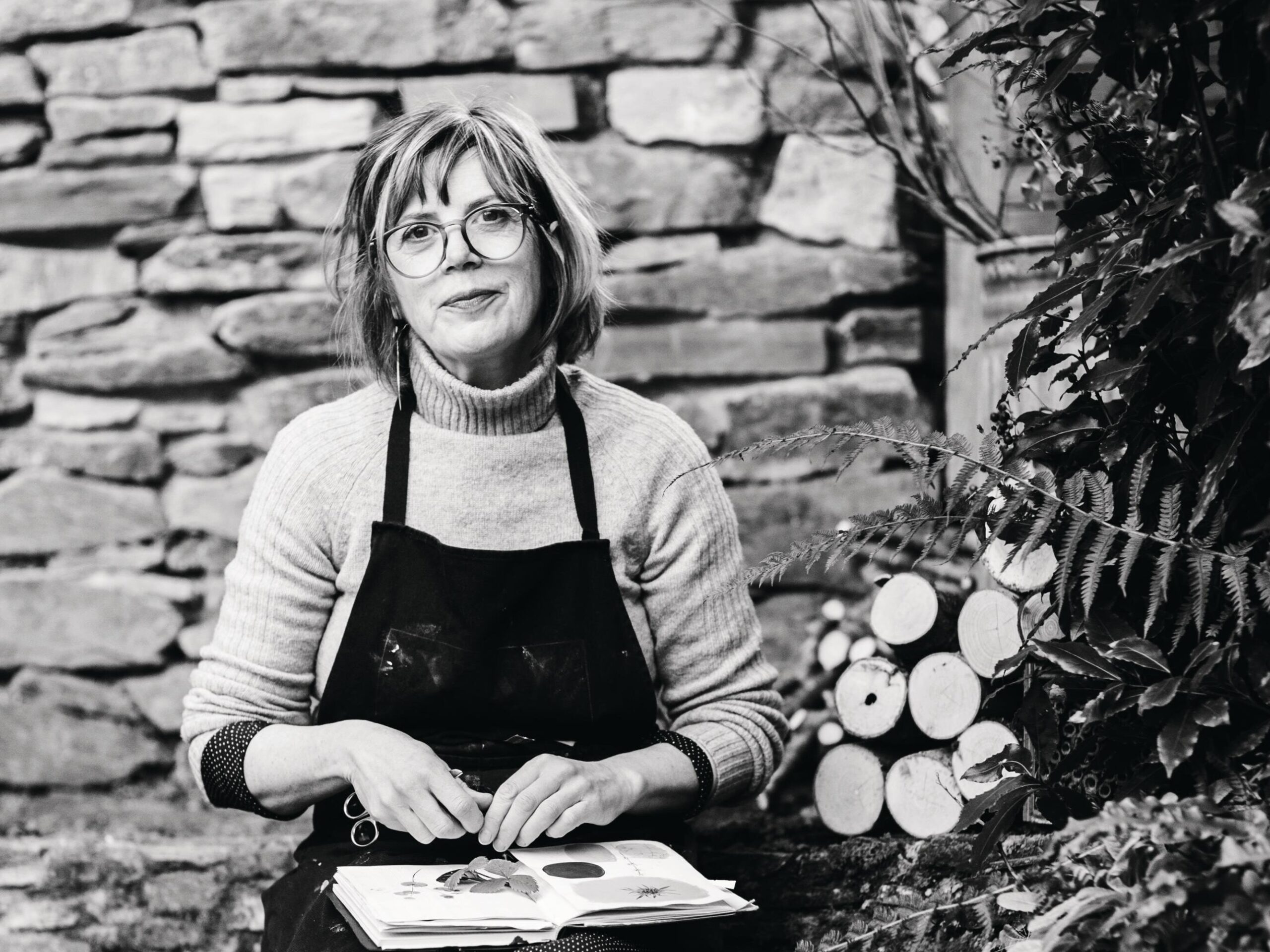 Allison Sylvester collecting leaves in her Totnes garden