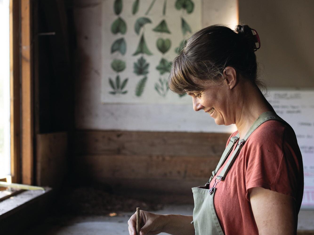 Woman indoors sorting seedlings