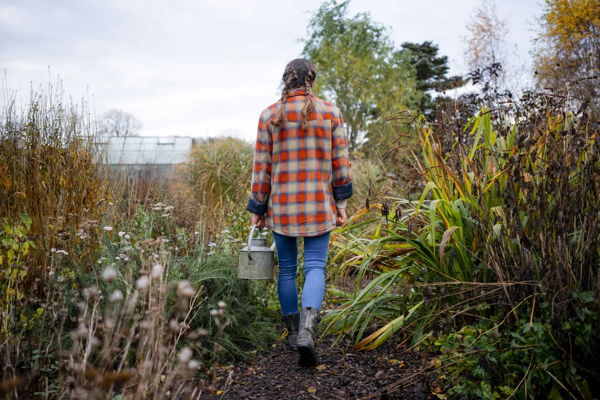 Busy in the Allotment Volunteer working outdoors on a community farm © SolStock /Getty