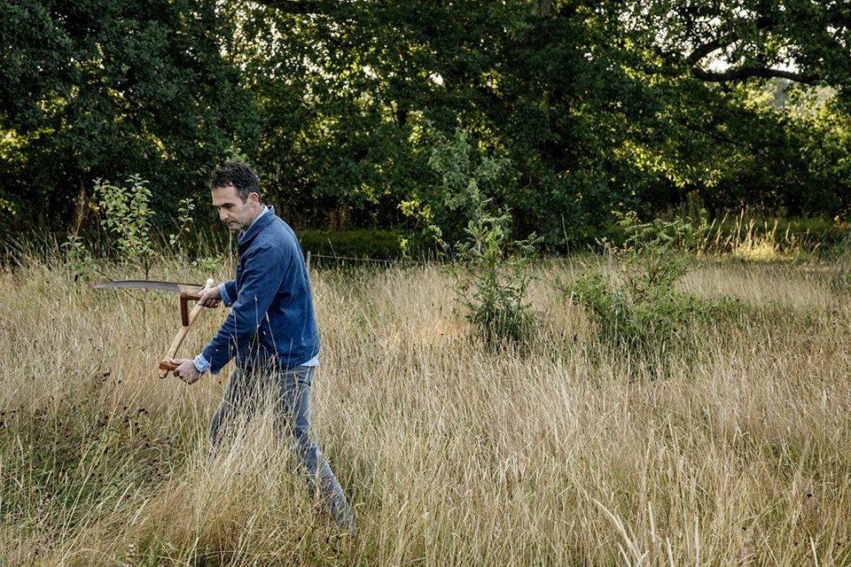 Troy Scott Smith, head gardener at Sissinghurst Castle Garden scything the meadow