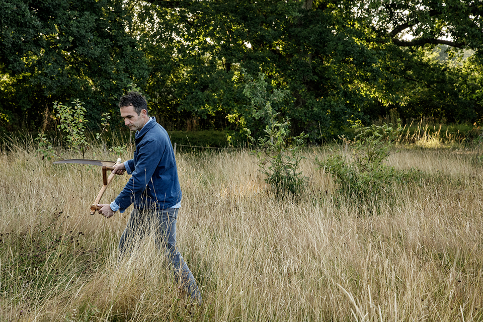 Troy Scott Smith, head gardener at Sissinghurst Castle Garden scything the meadow