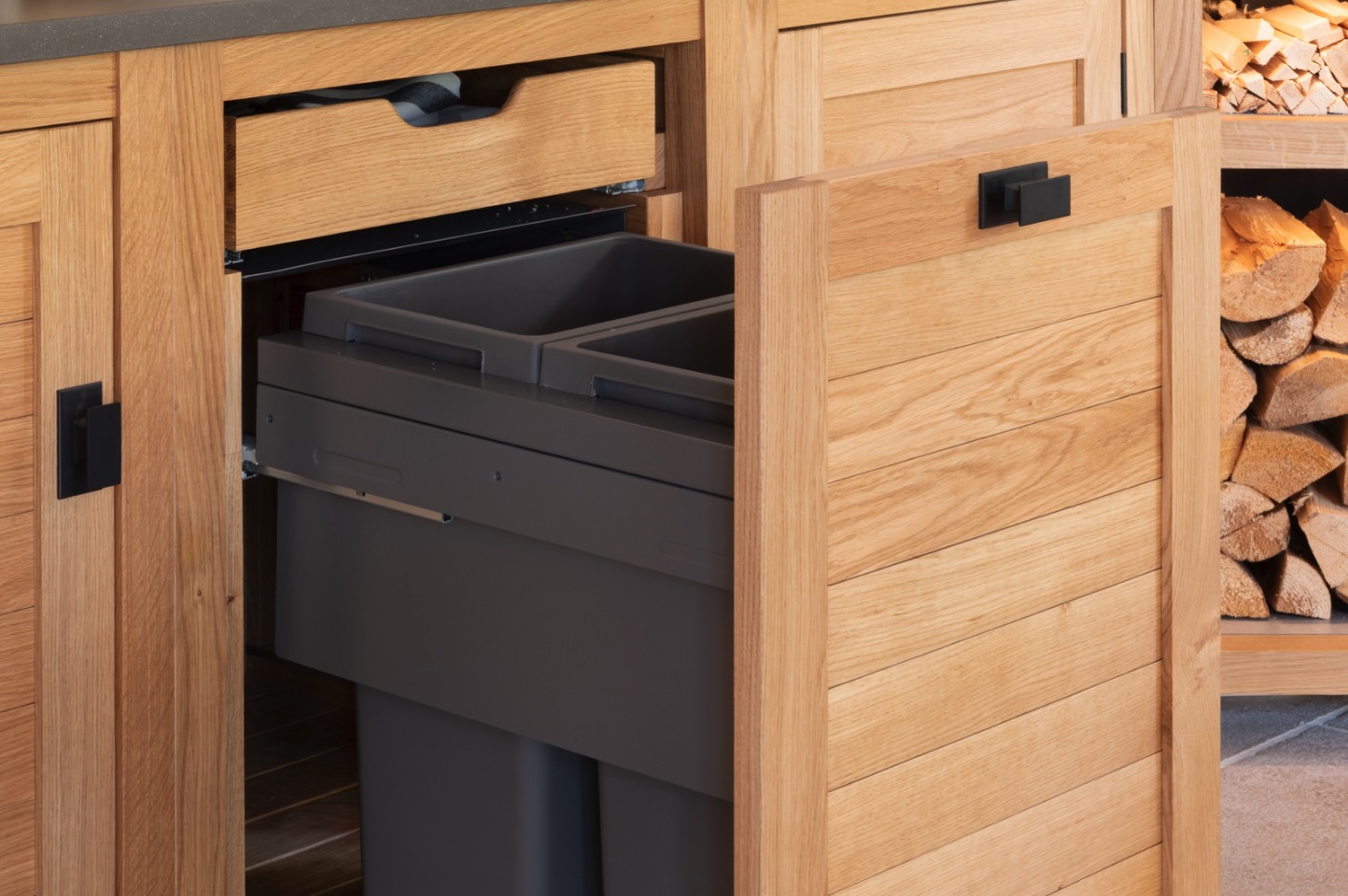 This Hampshire Beach House’s outdoor kitchen includes clever features like hidden bins