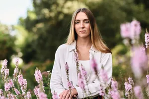 Emily Adcock horticulturist Woman sat in garden in spring