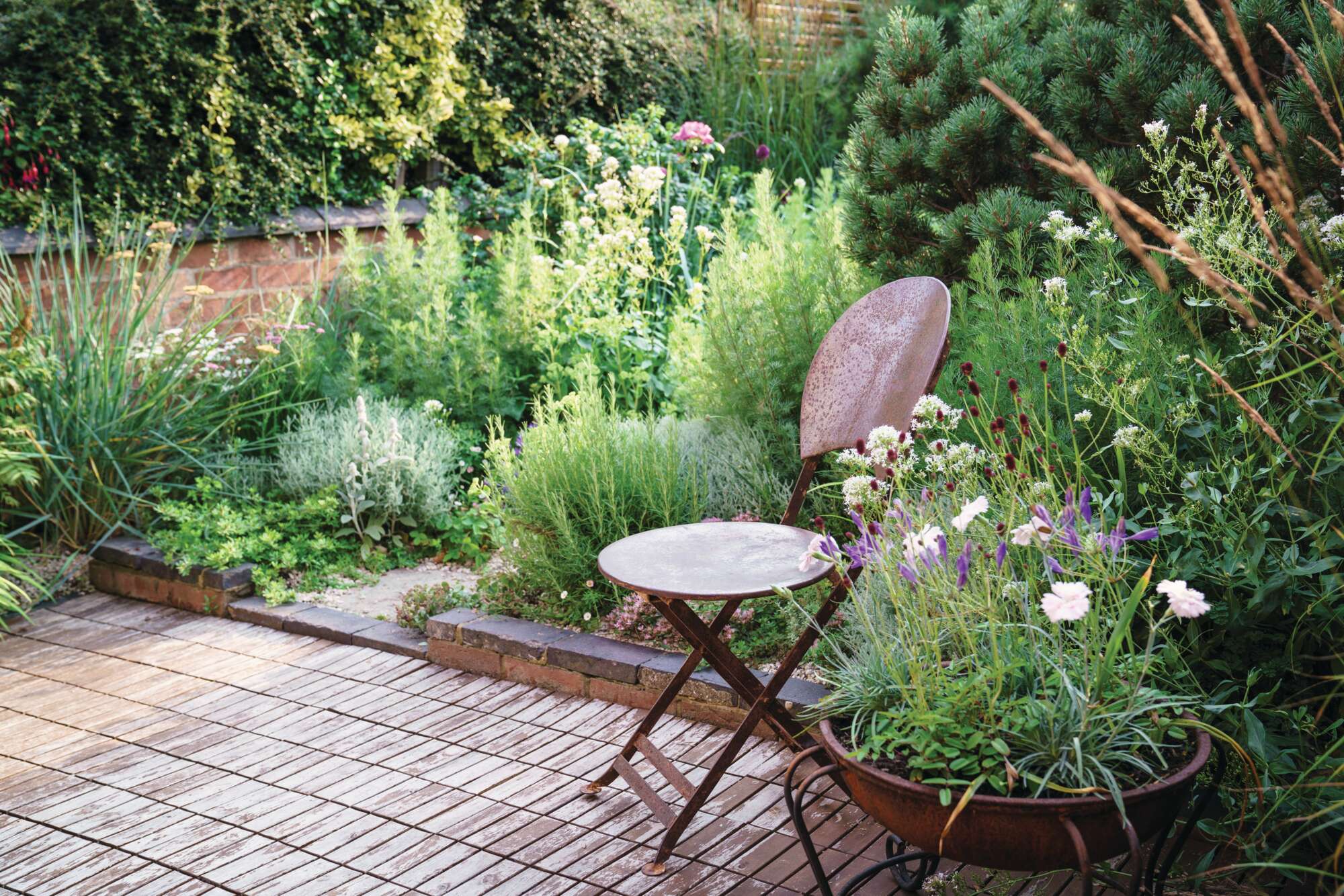 Even a small chair creates big impact in the right spot, such as this option in a small Northampton garden