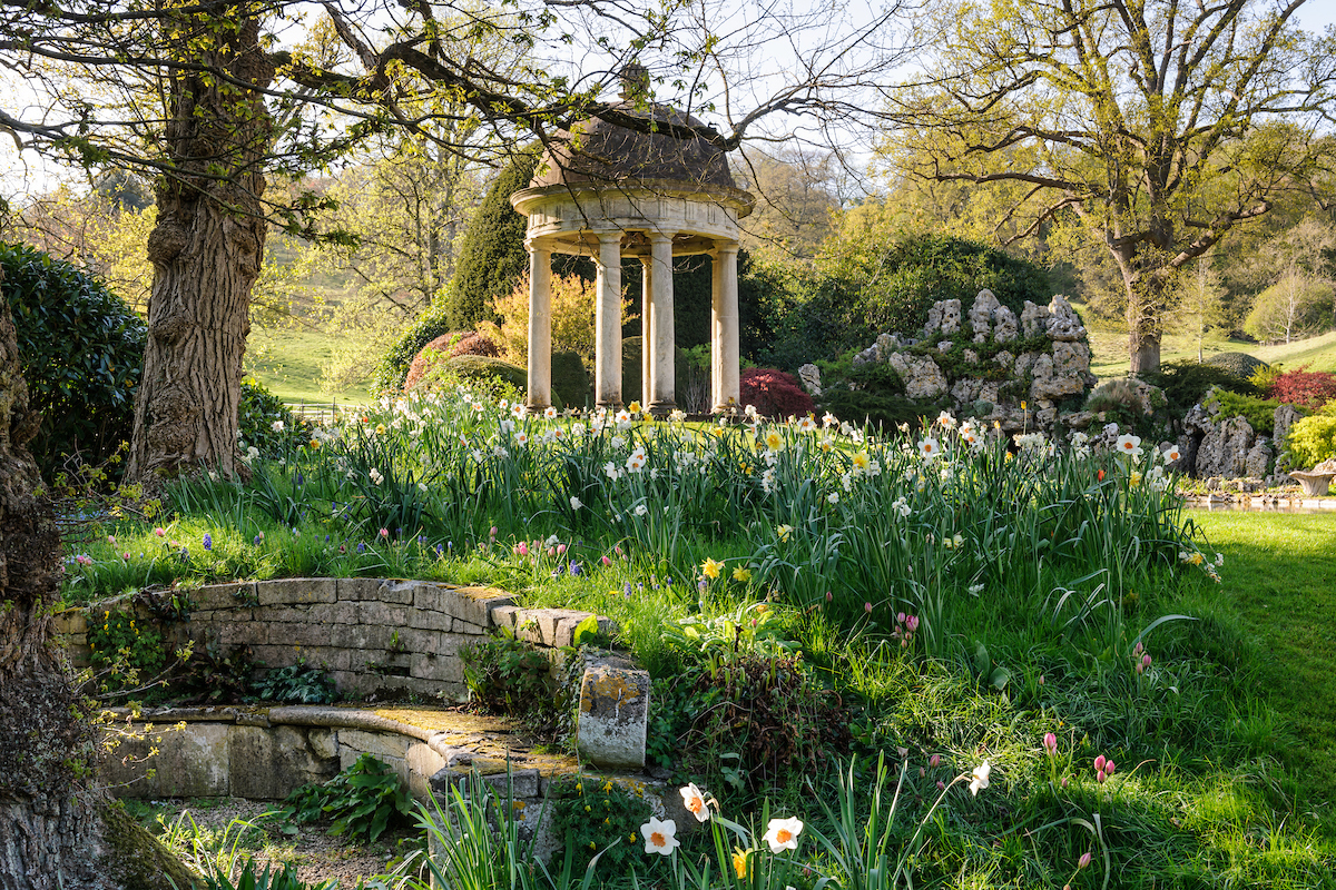 Belcombe Court gardens, designed with help from Arne Maynard, has a stone rotunda, pulling attention up from the lake below it