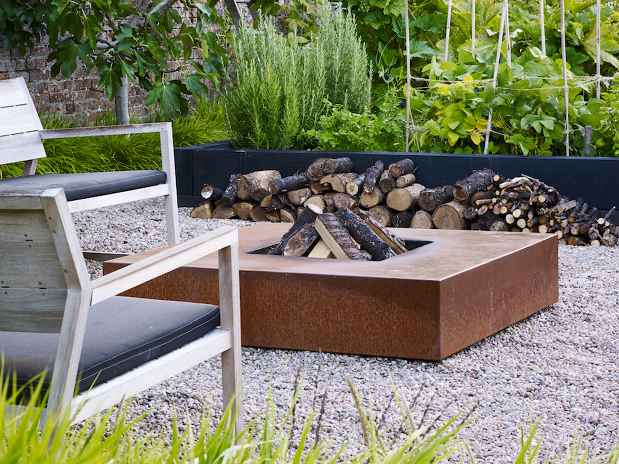 A square fire pit adds interest in this Hampshire garden by Helen Elks-Smith