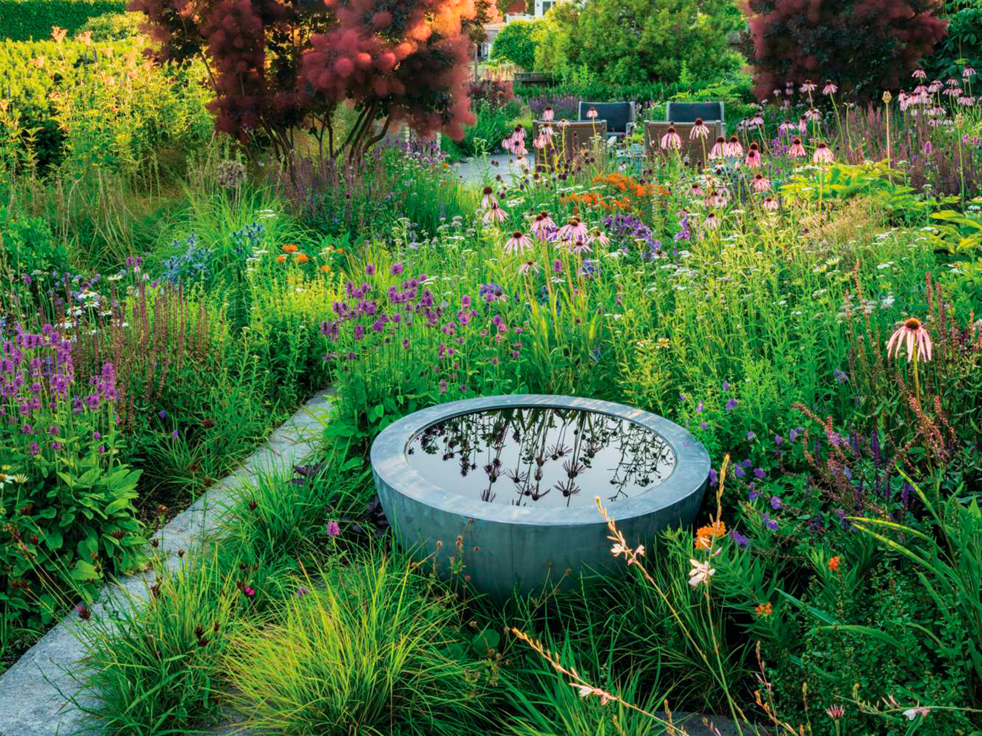 Designer Adam Woodruff placed a reflective water bowl in his coastal garden in Massachusetts, USA