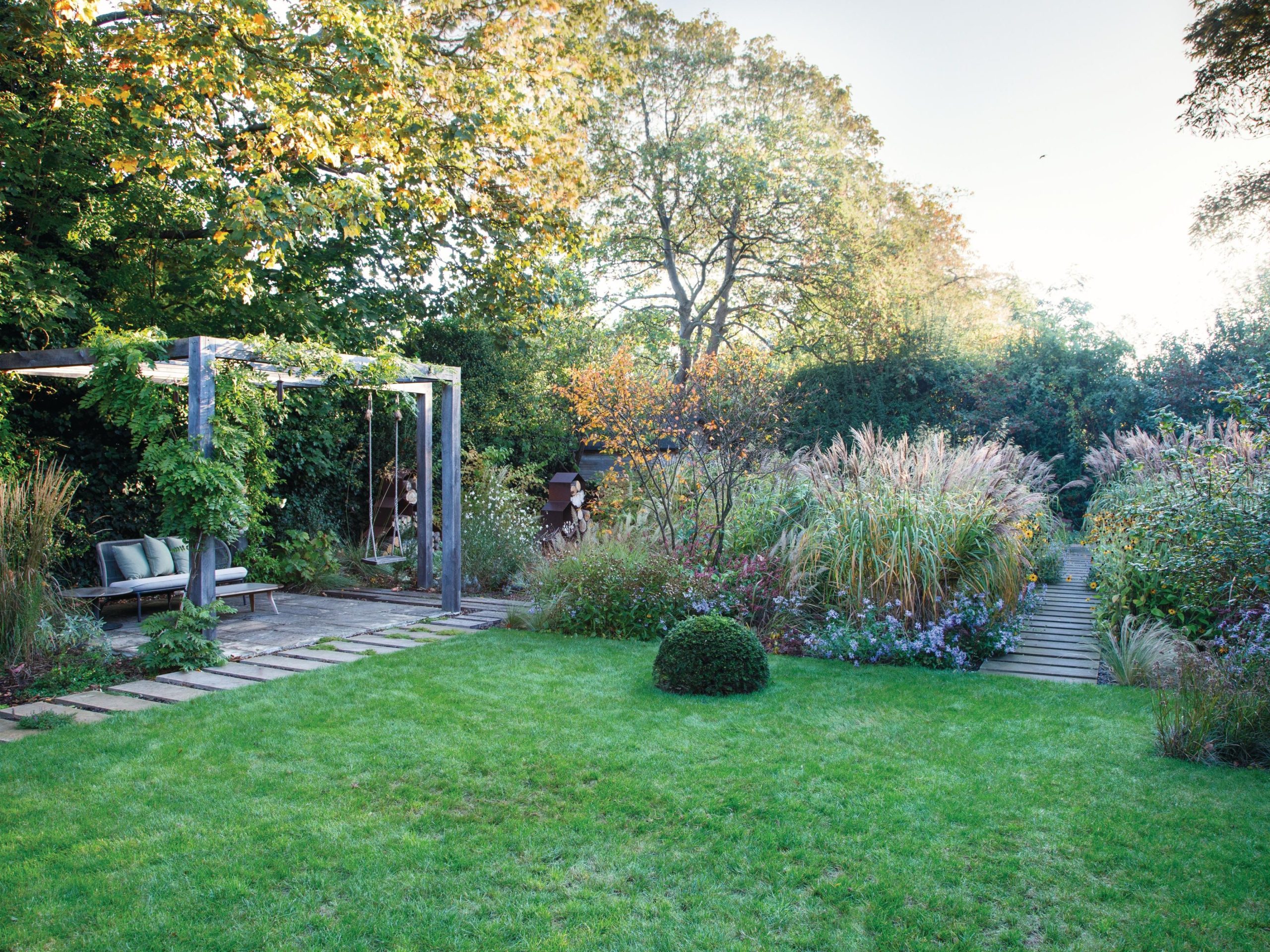 Garden lawn and pergola with seating and swing